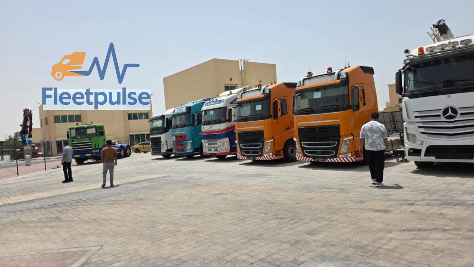 FleetPulse fleet lineup — Volvo FH tractor units and heavy trucks parked at the yard